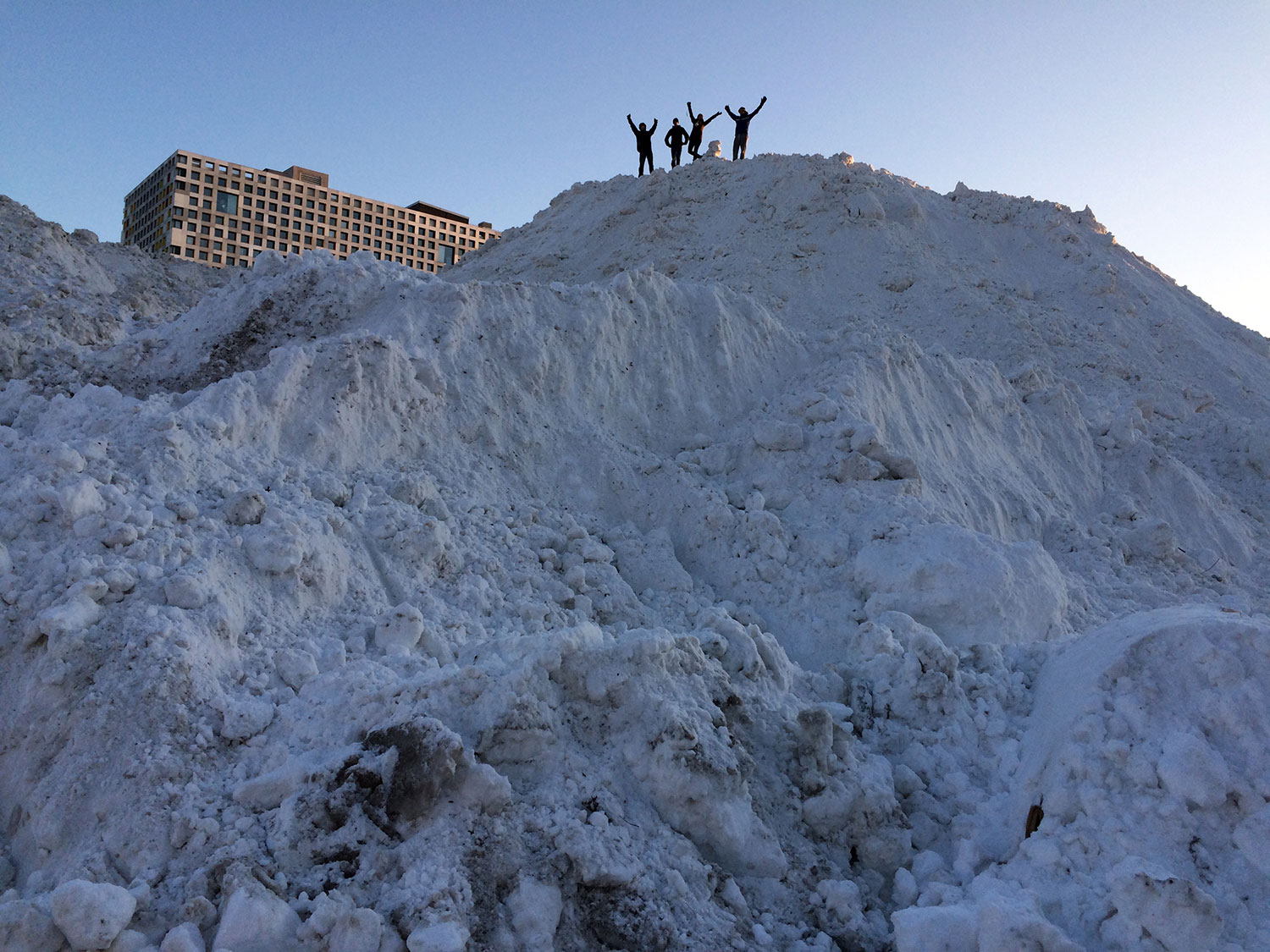 Students cheep atop a large snow mound dubbed the "Alps of MIT" (Credit: Tom Gearty/MIT).