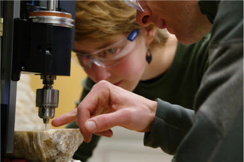 Graduate student Elena Steponaitis (left) with David McGee (right), drilling a rock sample - Image credit: Helen Hill