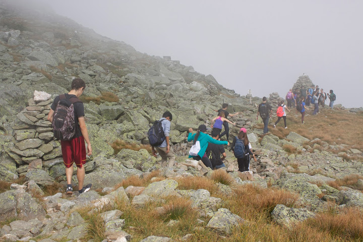 Students walk through a cloud as they navigate Mount Washington's rocky terrain. Credit: Min Ding